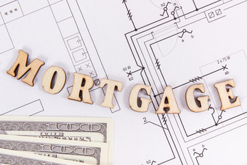 Inscription mortgage and money on construction diagrams of house
