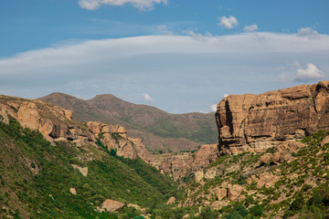 Landscape of canyon and mountains at Lesotho country in Africa. Blue sky and white clouds in a midday. Kingdom of mountain.