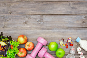 Naklejka na ściany i meble Top view of Healthy lifestyle concept, sport equipments and fresh foods on wood background. Top view with copy space.