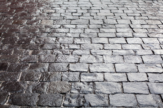 Cobblestones On Pavement Background, Stone Sidewalk Texture Gray Or Black Color, Wet Bricks Road Surface Pattern Top View Closeup