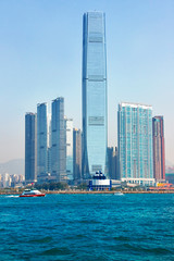 Fototapeta na wymiar Speedboat in Victoria Harbour with skyscrapers Hong Kong in the background 