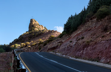 road to triangle hills. Cross sign of Christ religion over the peak. 