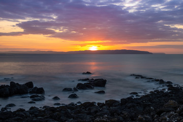 Rocky coast line of the Causeway Coast in Northern Ireland at sunset