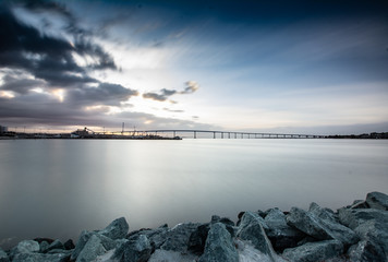 Long exposure of bay at dawn with bridge