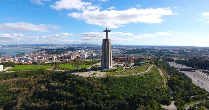 Aerial zoom in of The Sanctuary of Christ the King is a Catholic monument and shrine dedicated to the Sacred Heart of Jesus Christ overlooking the city of Lisbon