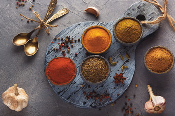 Various colorful spices on wooden table, top view