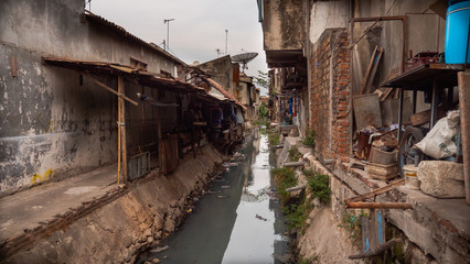 Poor area with slums and sewers in Indonesia. Poor asian city block