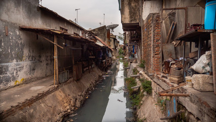 Fototapeta premium Poor area with slums and sewers in Indonesia. Poor asian city block