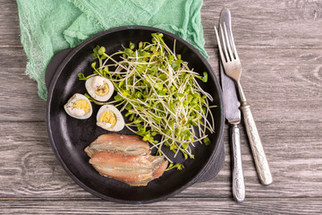 Unusual salad with leek sprouts, quail eggs and anchovies