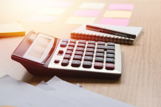 Calculator Mathematical, financial and accounting objects placed on the office desk in the office.