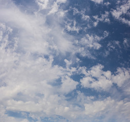 Spindrift clouds of good weather on blue sky. Fantastic skies on the planet earth. The sun is hidden.