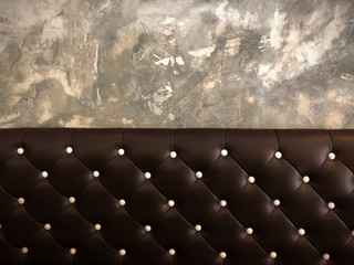 shameless beautiful vintage dark leather cushion sofa, background of white buttoned on luxury brown leather pattern and concrete wall, Vip luxury brown leather with cement wall, loft style background