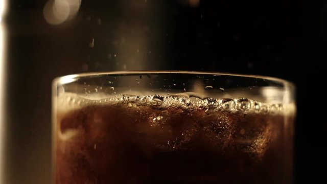 Carbonated beverage pouring in slow motion - extreme close-up