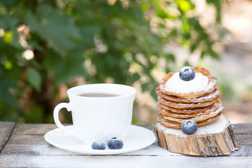 A stack of delicious pancakes with honey and blueberries on a wood background. with copy space