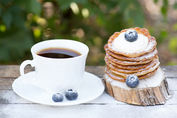 A stack of delicious pancakes with honey and blueberries on a wood background. with copy space