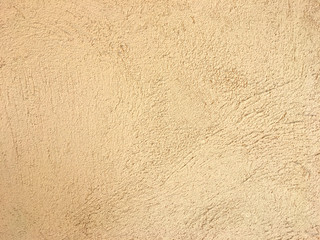 Rough light yellow concrete wall texture. Wrinkle pattern after plaster background.