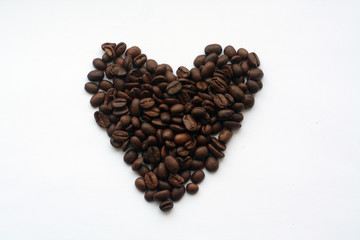 Coffee beans in heart form on white.
