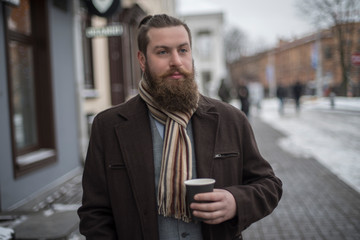 man with a beard drinking coffee