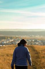 women in the countryside. woman walking on hill