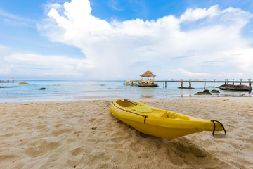 Yellow kayak boat on sea beach summer vacation concept