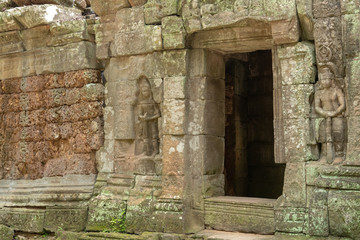 Fototapeta na wymiar Stone doorway and bas-reliefs at ruined temple