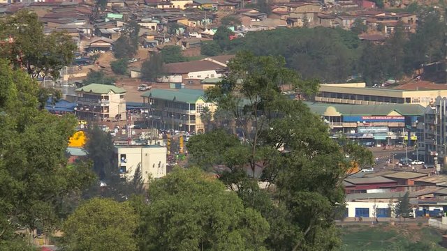 Two clips. Top street-scene near the central bus-station, a busy part of town with many shops; Kigali, Rwanda.
