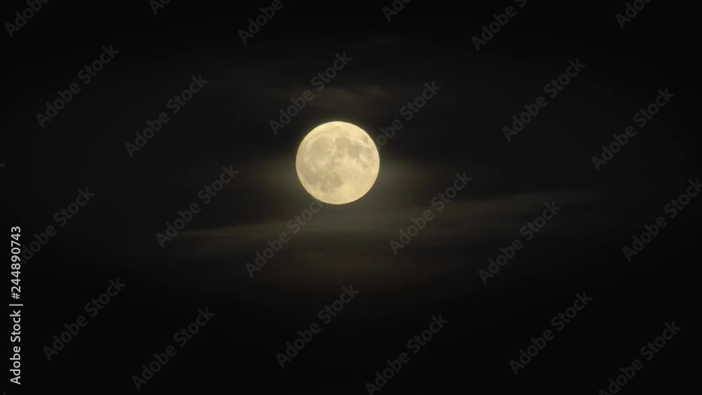 Wall mural full moon in night sky surrounded by scary clouds and dark black sky