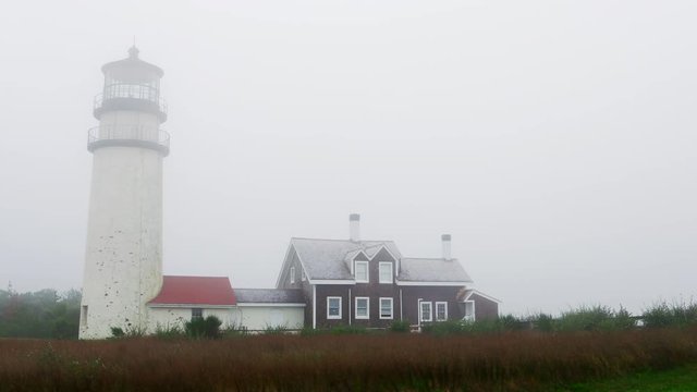 Fog rolls past the Highland Light (Cape Cod Light) on the Cape Cod National Seashore in North Truro, Massachusetts.