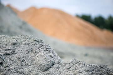 Large piles of construction sand and gravel used for asphalt production and building. Limestone quarry, mining rocks and stones 