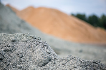 Large piles of construction sand and gravel used for asphalt production and building. Limestone quarry, mining rocks and stones 