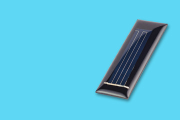 One new rectangular solar cell protected of transparent silicone or resin on blue table with copy space for your text. Green or alternative or eco energy concept