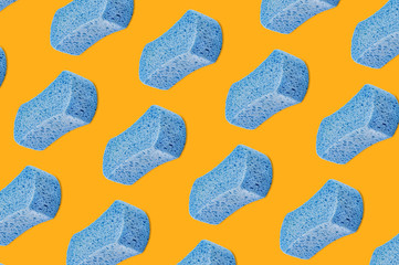 Diagonal rows of porous blue sponges on yellow background