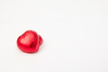 Red heart of Chocolate sweet candy on white wooden background for Valentines Day,Copy space for your text.