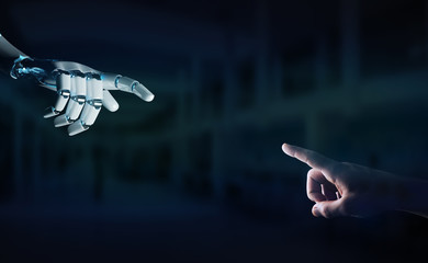 Robot hand making contact with human hand on dark background 3D rendering