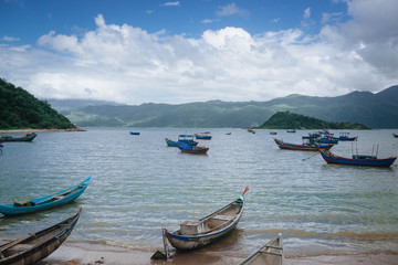 Naklejka na ściany i meble Bay, a village in Vietnam, with fishermen, boats on the background of the sea