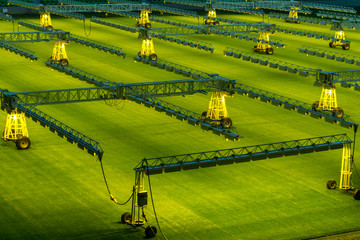 Mobile grow lighting system in sports stadium at night.