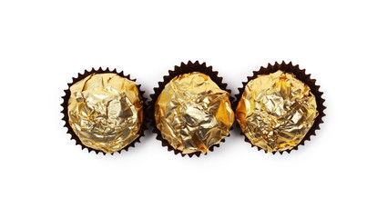 Chocolate balls in wrapping isolated on white, top view