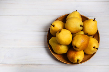 Yellow sweet pears and apple on a white wooden background. Copy space. Design elements.
