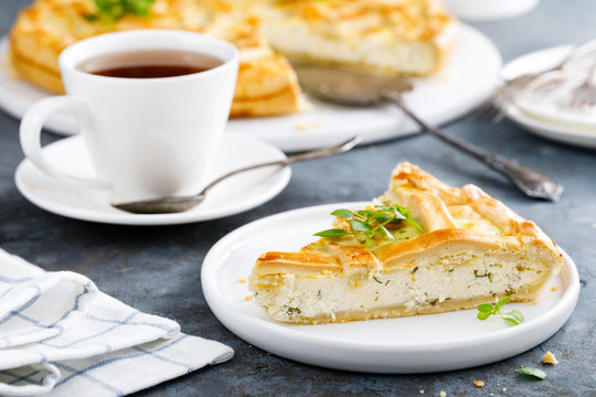 Pie with salted soft cheese and greens