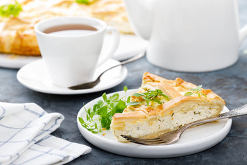 Pie with salted soft cheese and greens