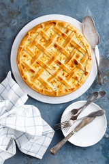 Pie with salted soft cheese and greens, top view