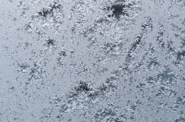 On the glass frozen moisture in the winter day formed a beautiful, fantastic patterns, unpredictable compositions.