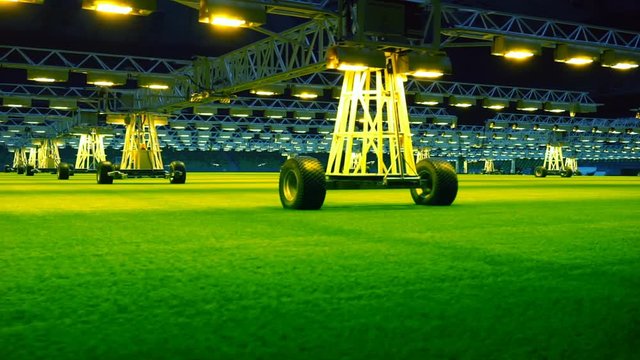 Mobile grow lighting system in sports stadium at night.