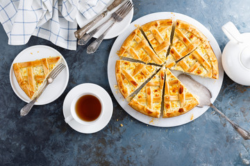 Pie with salted soft cheese and greens, top view
