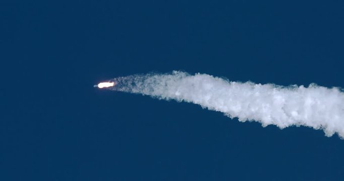 ICBM missile rocket flying into space with exhaust flames and smoke in 4K.