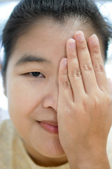 Beautiful Asian Woman Closing her eye with her palm hand