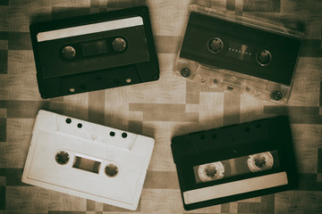 Several music cassette tapes on an orange background