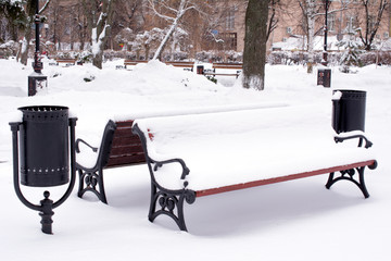 Snow Covered Park Bench. Snow covered bench in park. Snow covered bench. Winter scene. winter Park.