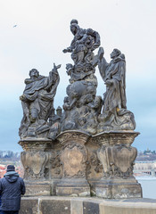Fototapeta na wymiar Prague, Czech Republic, Charles bridge. Sculpture of Madonna with Saints Dominic and Thomas Aquinas. In the center of the composition is the virgin Mary with little Jesus hovering over the globe