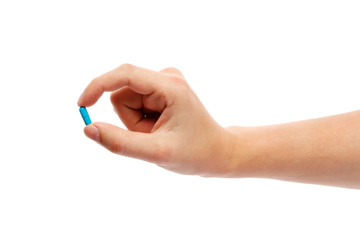 Blue pill in hand isolated on white background